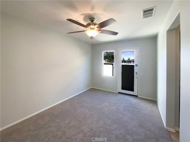 carpeted empty room with ceiling fan