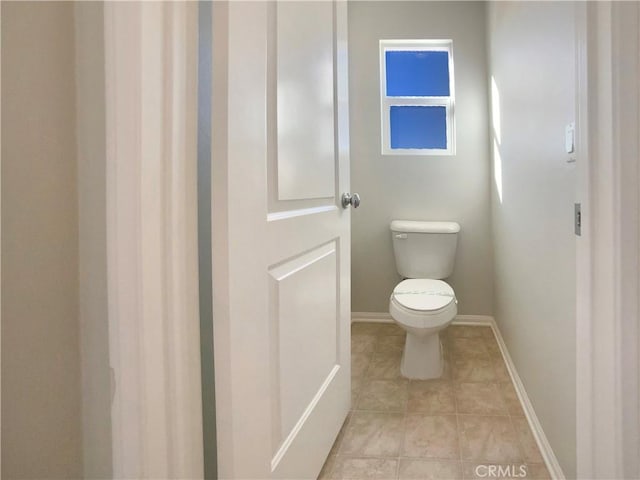 bathroom featuring tile patterned flooring and toilet