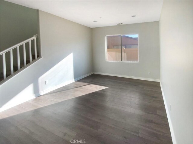 unfurnished room with hardwood / wood-style floors