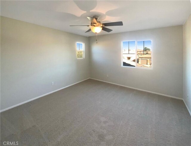 unfurnished room with a healthy amount of sunlight, ceiling fan, and carpet