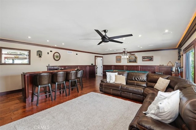 living room with wet bar, crown molding, dark hardwood / wood-style floors, and billiards