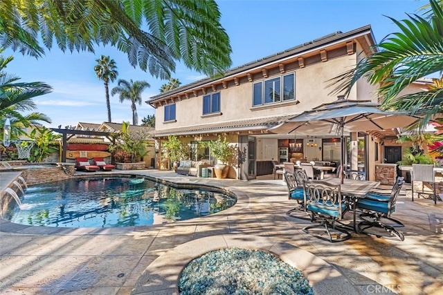 view of swimming pool with pool water feature, a patio area, and a pergola