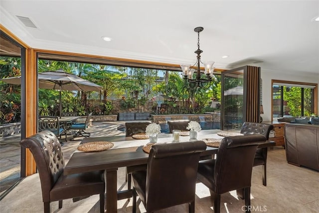 dining area with an inviting chandelier and crown molding