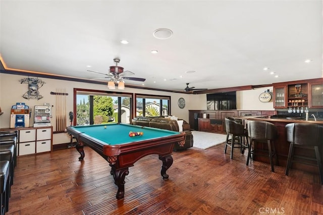 recreation room with indoor wet bar, dark hardwood / wood-style flooring, crown molding, and pool table