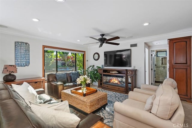 living room with ceiling fan and ornamental molding