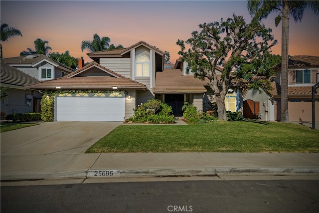 view of front property with a garage and a lawn