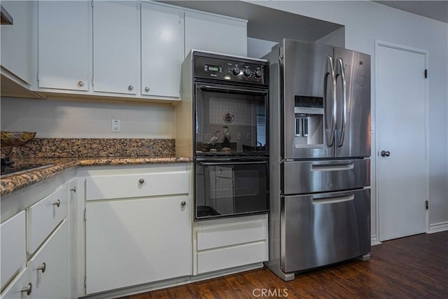 kitchen featuring double oven, stainless steel fridge, dark hardwood / wood-style floors, and white cabinetry