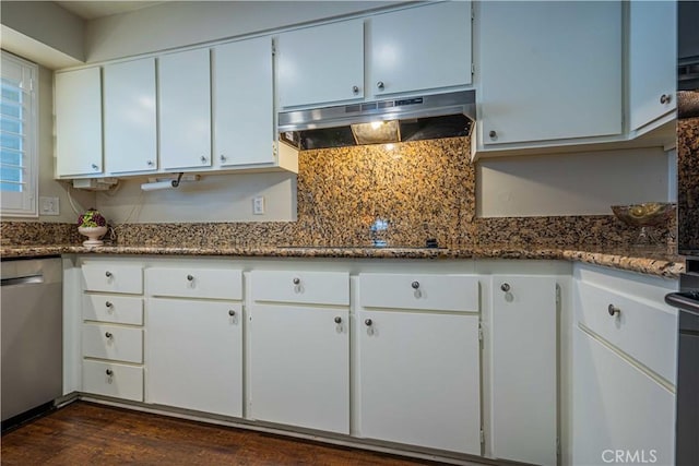 kitchen with dark stone counters, stainless steel dishwasher, and white cabinetry