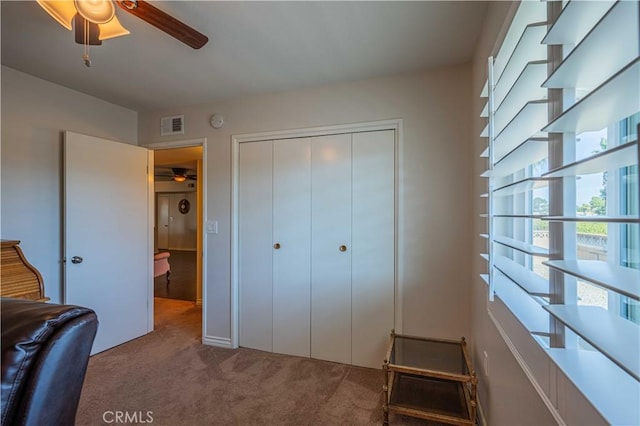 bedroom featuring ceiling fan, a closet, and carpet flooring