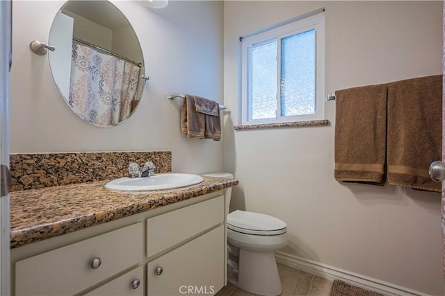 bathroom featuring vanity and toilet