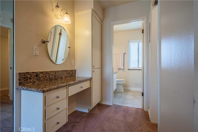 bathroom featuring toilet and vanity