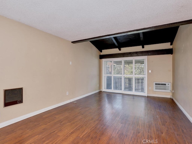 unfurnished room with a textured ceiling, a wall mounted AC, vaulted ceiling with beams, and dark wood-type flooring