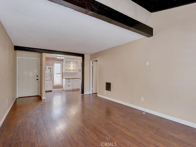 unfurnished living room with hardwood / wood-style flooring and a textured ceiling