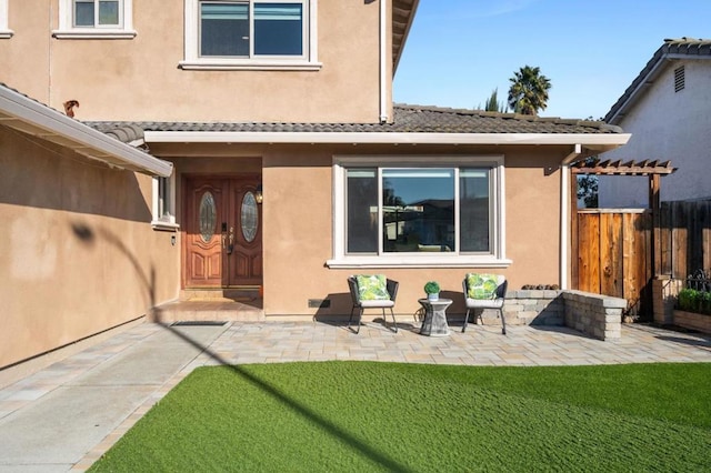 back of property with a patio and a lawn