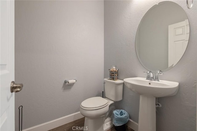 bathroom featuring sink, hardwood / wood-style floors, and toilet