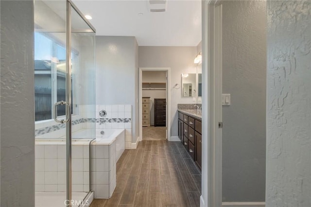 bathroom with vanity and plus walk in shower