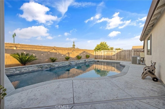 view of pool with a patio and central AC