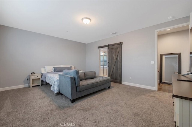 carpeted bedroom featuring a barn door