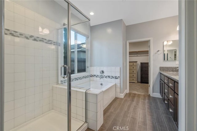 bathroom with independent shower and bath and vanity