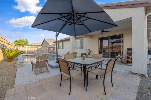 view of patio / terrace featuring ceiling fan and a fenced in pool