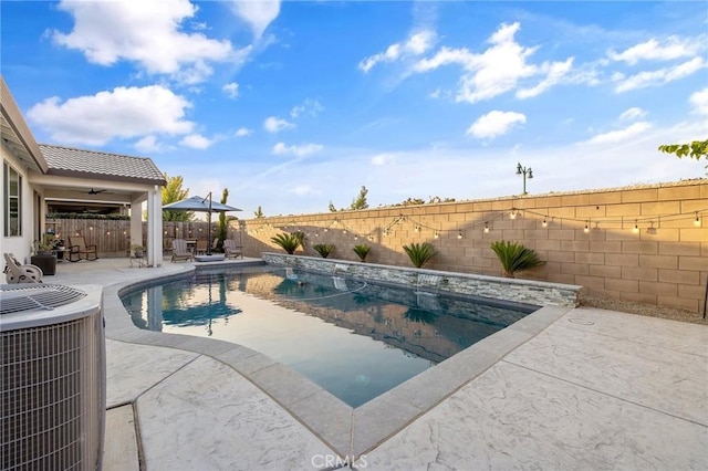 view of pool featuring central air condition unit and a patio area