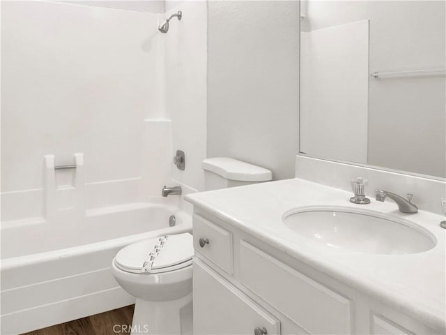 full bathroom with toilet, hardwood / wood-style flooring, shower / bath combination, and vanity