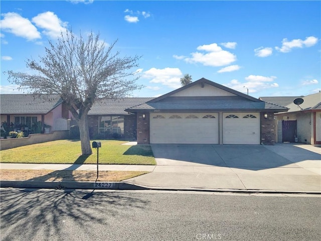 single story home with a garage and a front lawn