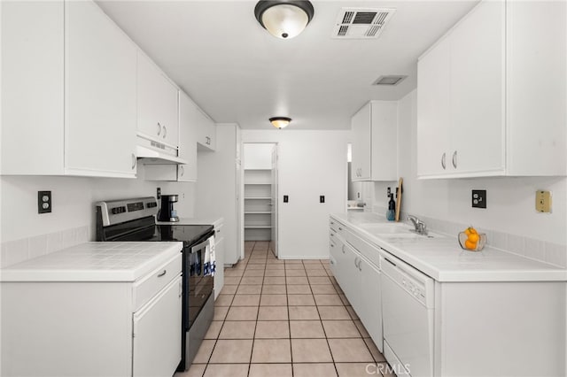 kitchen featuring white dishwasher, under cabinet range hood, a sink, visible vents, and stainless steel electric stove