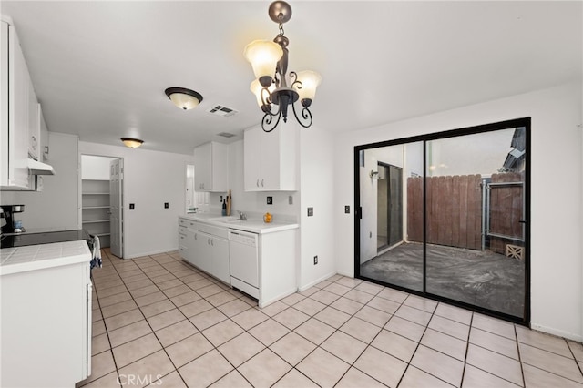 kitchen featuring light tile patterned floors, tile countertops, white dishwasher, visible vents, and white cabinets