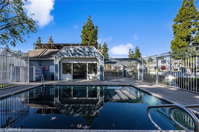 pool featuring a patio and fence