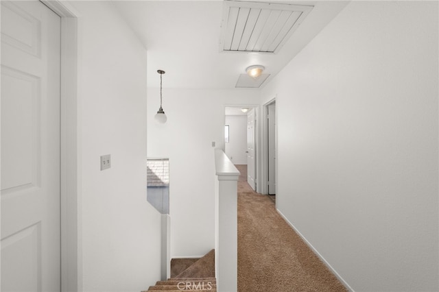 corridor featuring light carpet and an upstairs landing