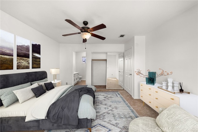 bedroom featuring a closet, visible vents, carpet flooring, connected bathroom, and ceiling fan