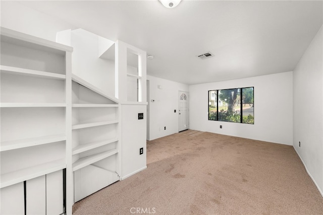 unfurnished room with carpet and visible vents