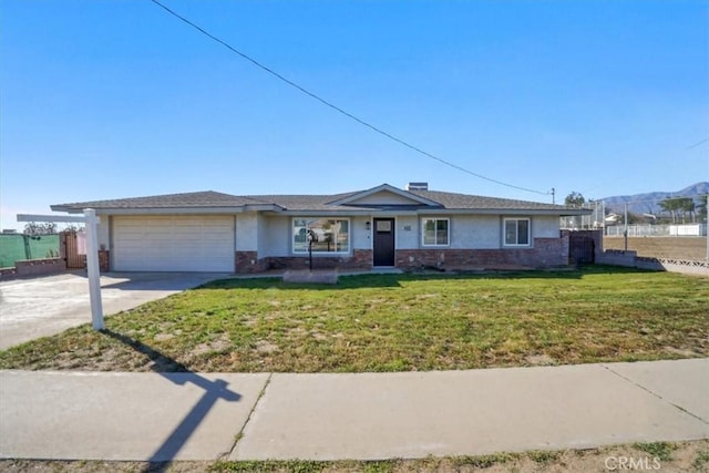 ranch-style home with a garage, a mountain view, and a front lawn