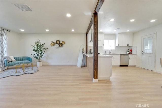 kitchen with dishwasher, decorative backsplash, light wood-type flooring, white cabinets, and sink