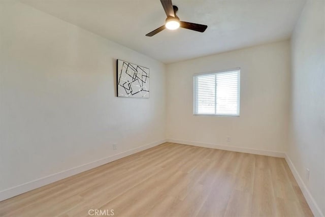 spare room featuring light wood-type flooring and ceiling fan