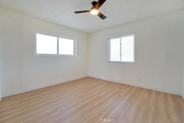 spare room with light hardwood / wood-style floors and ceiling fan