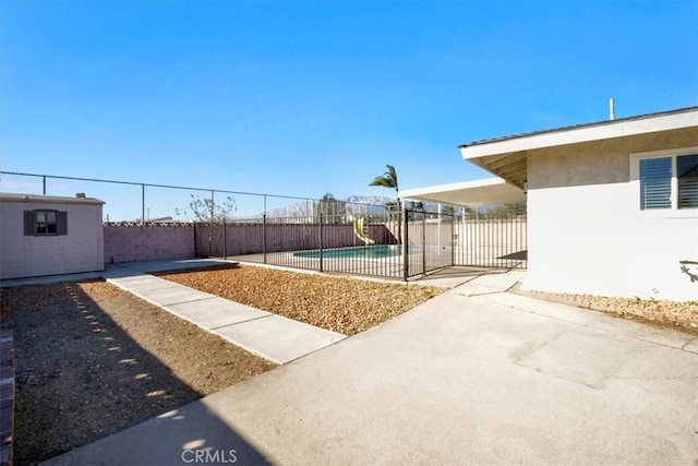 exterior space featuring a fenced in pool and a patio