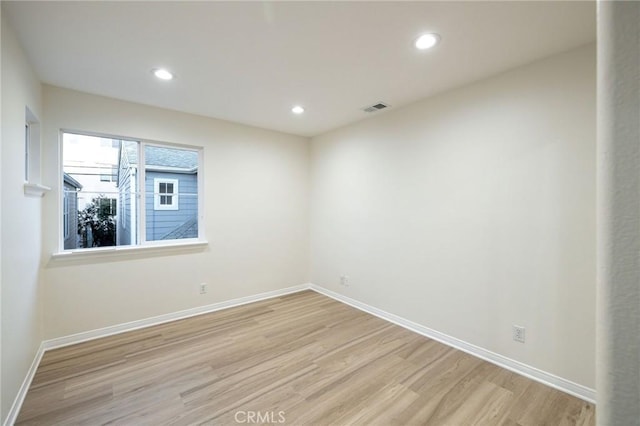 spare room featuring light hardwood / wood-style floors