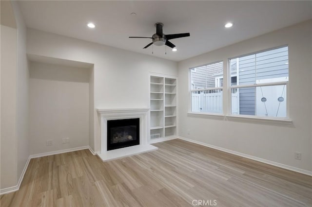 unfurnished living room featuring ceiling fan and light hardwood / wood-style floors