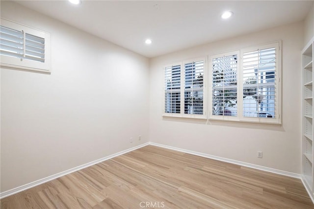 spare room featuring light hardwood / wood-style floors and plenty of natural light