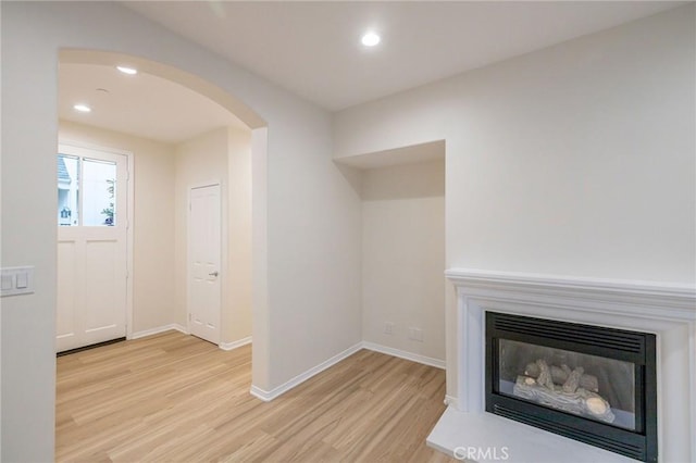 unfurnished living room featuring light wood-type flooring