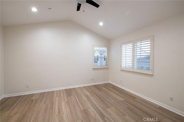 unfurnished room featuring ceiling fan, light hardwood / wood-style flooring, and vaulted ceiling