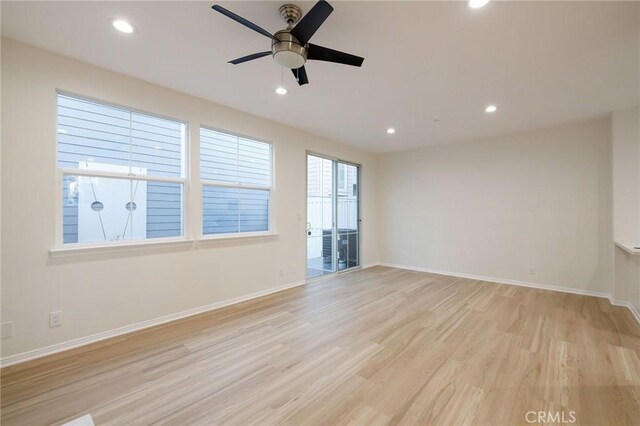 spare room featuring ceiling fan and light hardwood / wood-style flooring