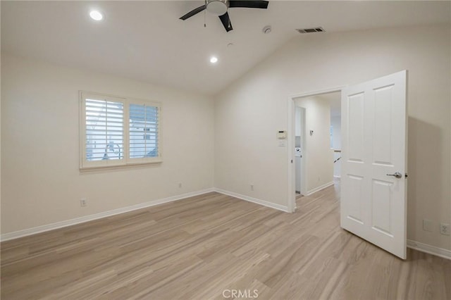 unfurnished room with lofted ceiling, ceiling fan, and light hardwood / wood-style flooring