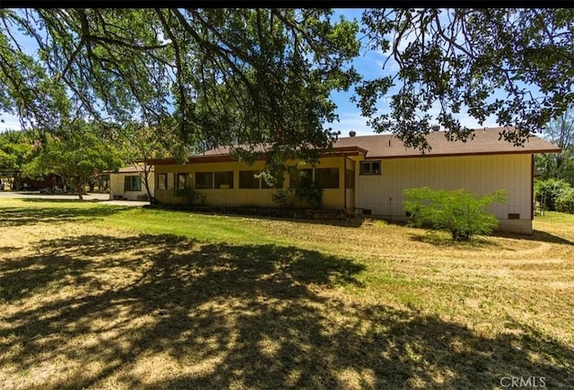 back of property featuring a yard