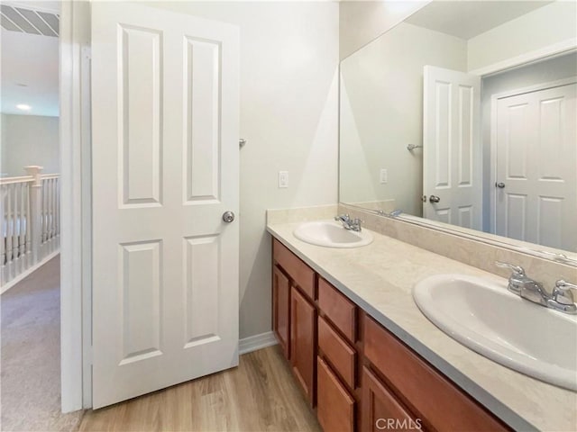 bathroom with hardwood / wood-style flooring and vanity