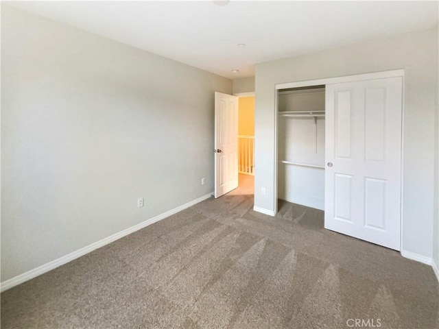 unfurnished bedroom featuring carpet and a closet