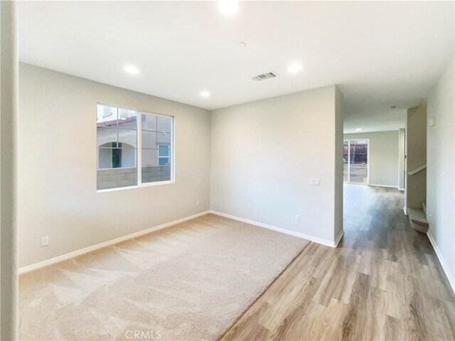 unfurnished room with light hardwood / wood-style floors