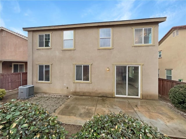 back of property with a patio and central air condition unit